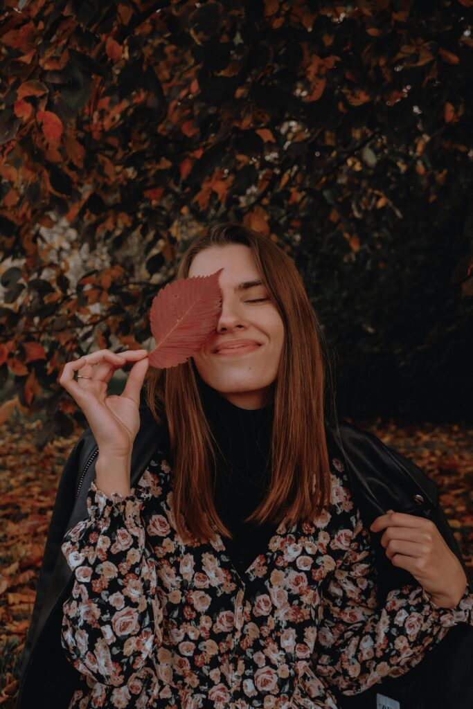 Woman Holding a Fall Leaf over Her Eye