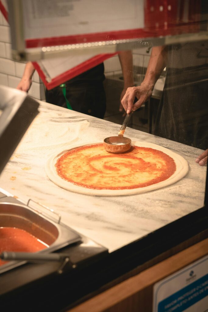 Person Making a Pizza