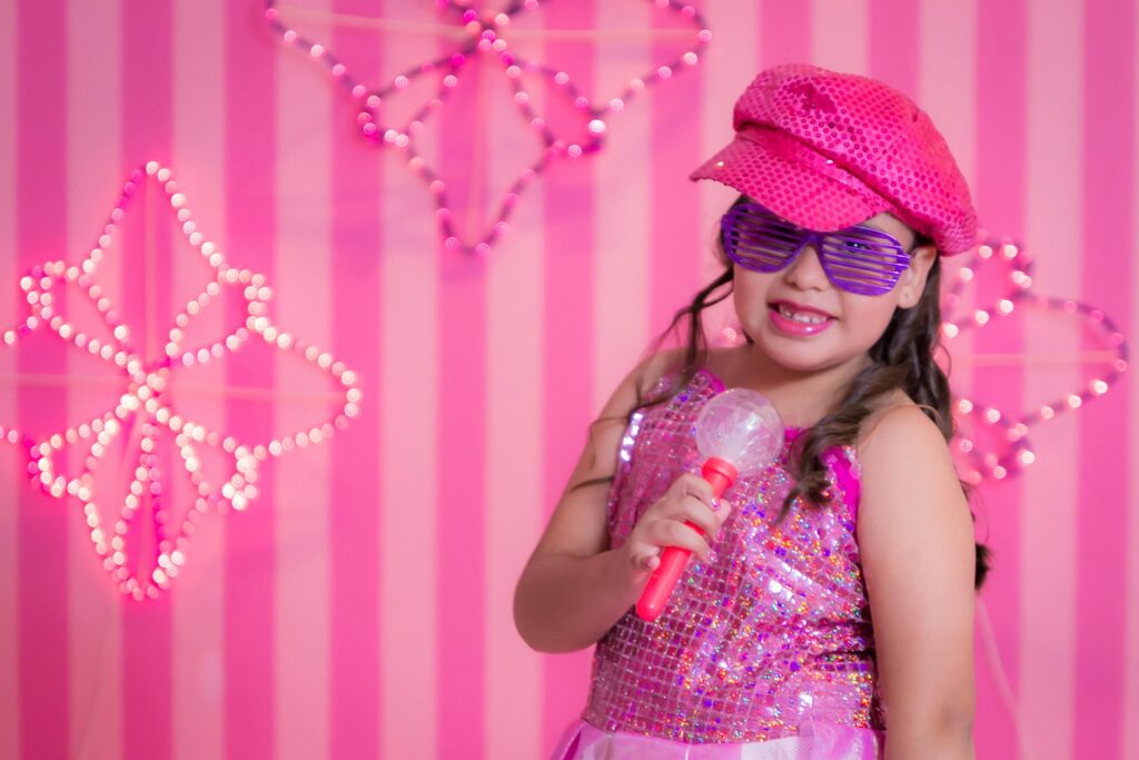 Little Girl Dressed in Pink with a Microphone