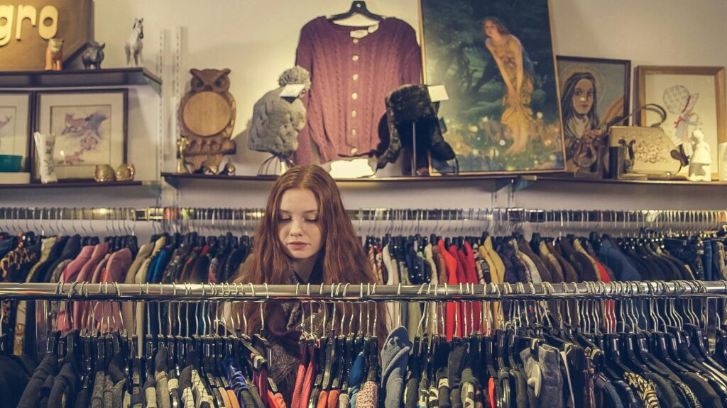 Girl Shopping Racks of Clothes