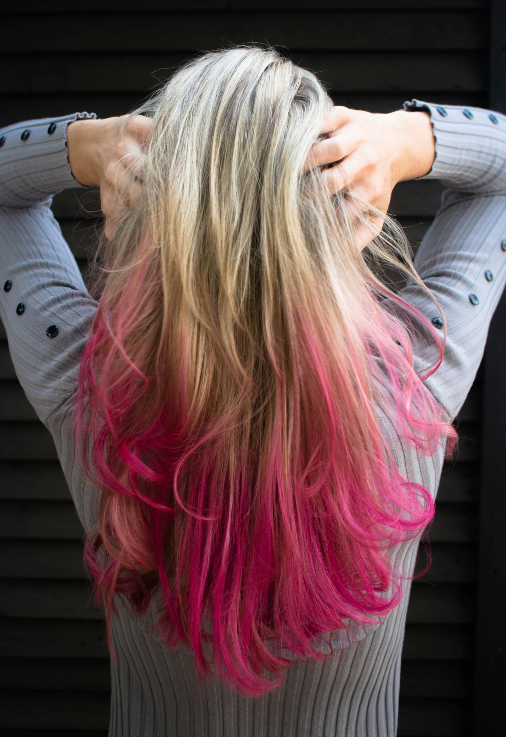 Woman with blond hair and pink ends