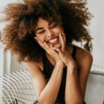 Woman Smiling Sitting in a Chair