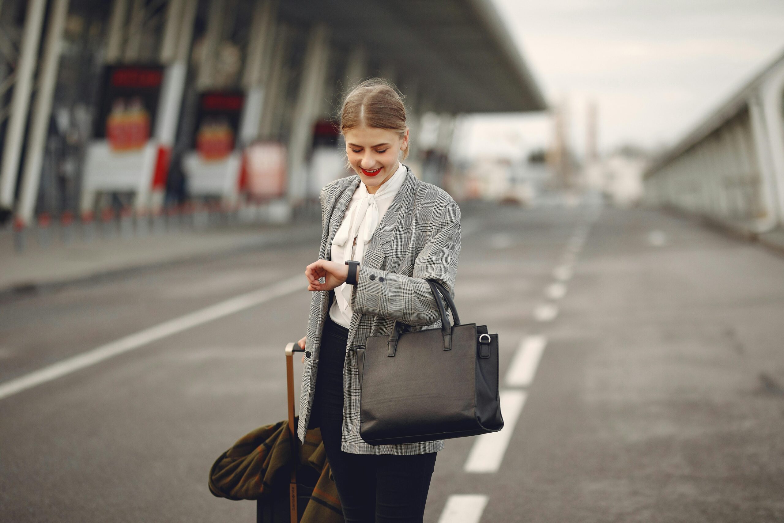 Woman traveling with briefcase and looking at watch