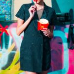 Woman Standing Eating French Fries