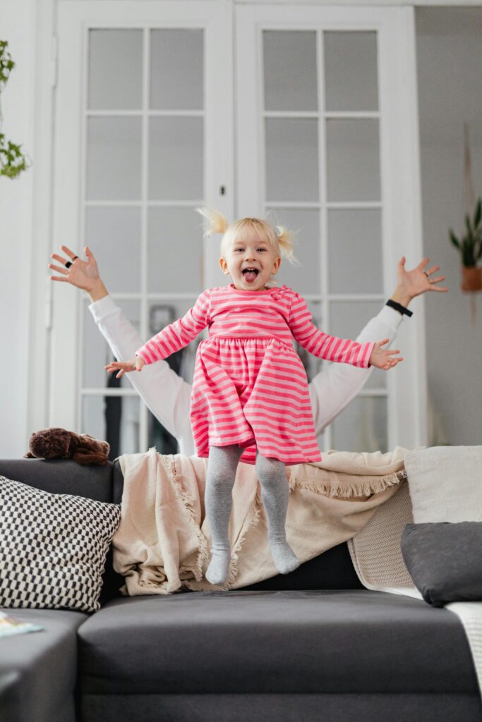 Little Girl Jumping on a Couch