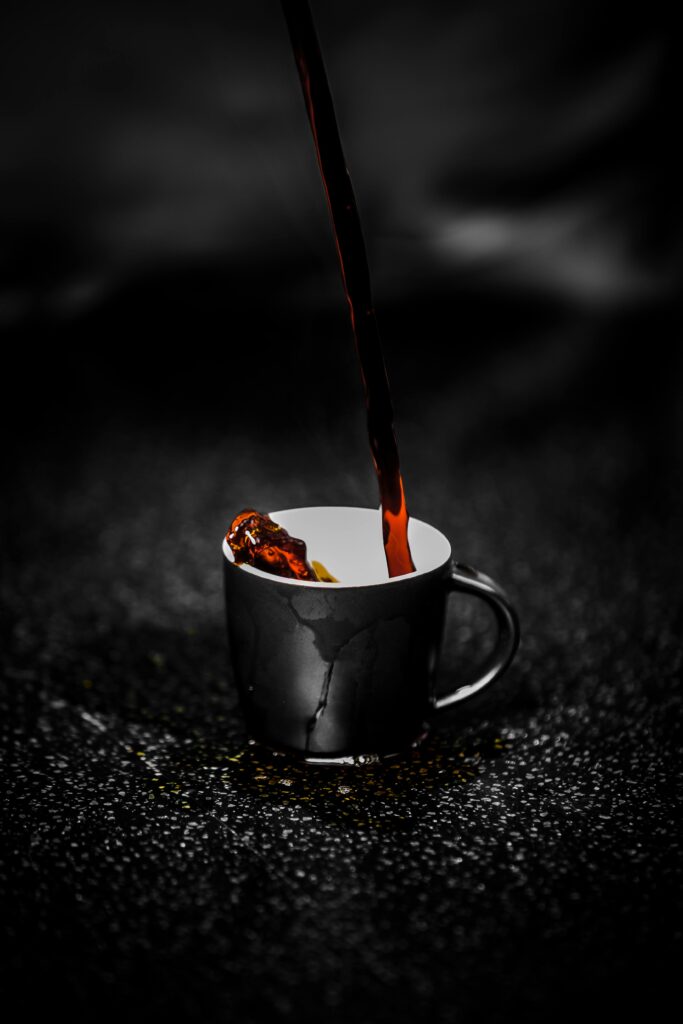 Person Pouring Coffee in a Cup