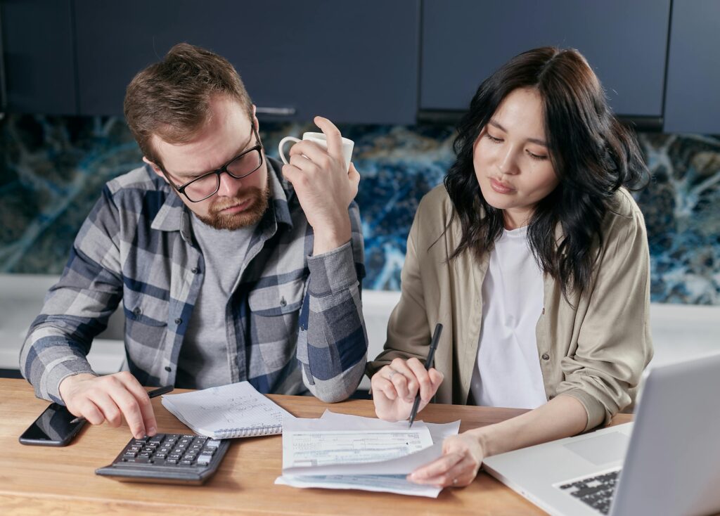 Man and Woman Looking at Bills