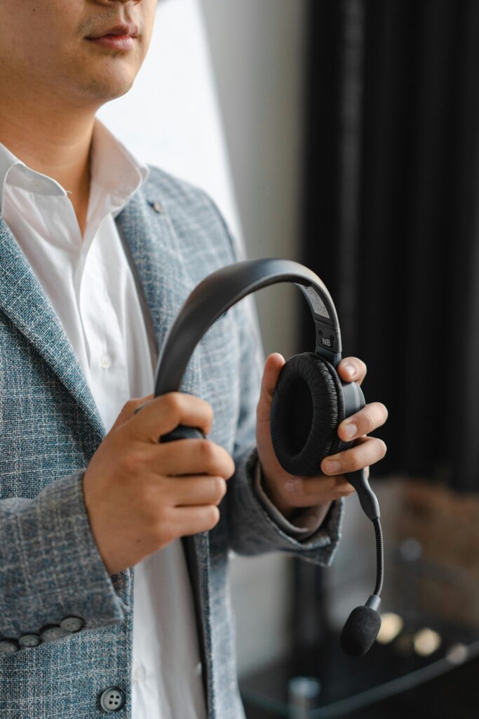 Woman Holding Headphones