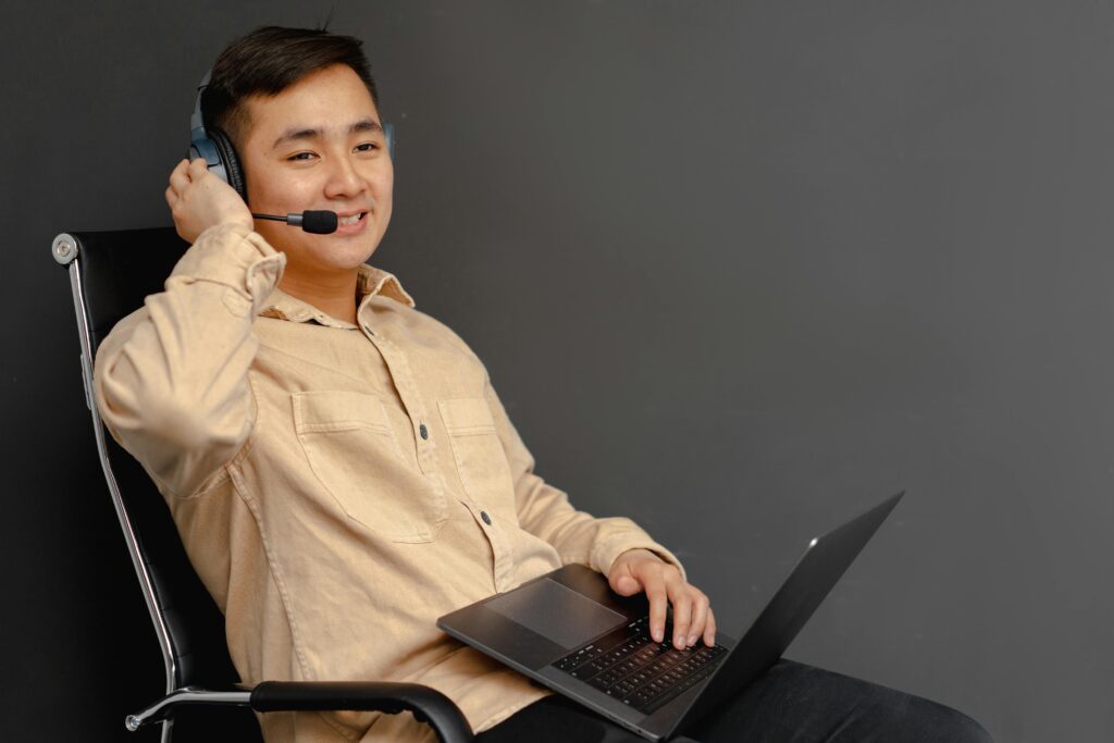 Man on a Laptop Wearing a Headset