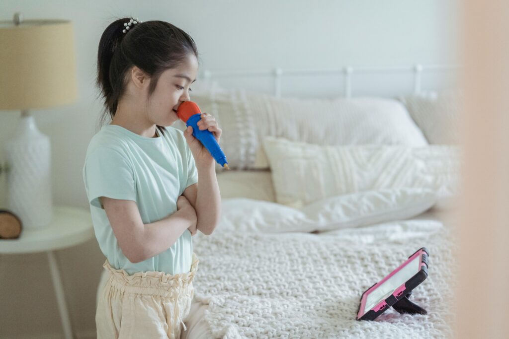 Little Girl Singing Karaoke with a Laptop