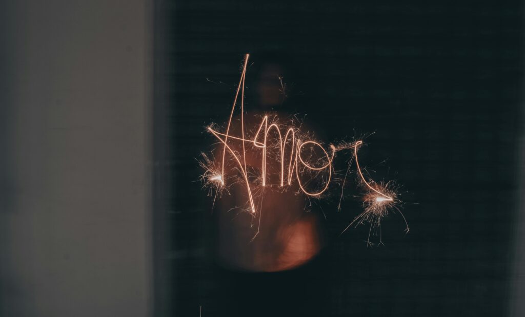 Woman Writing Amor with a Sparkler