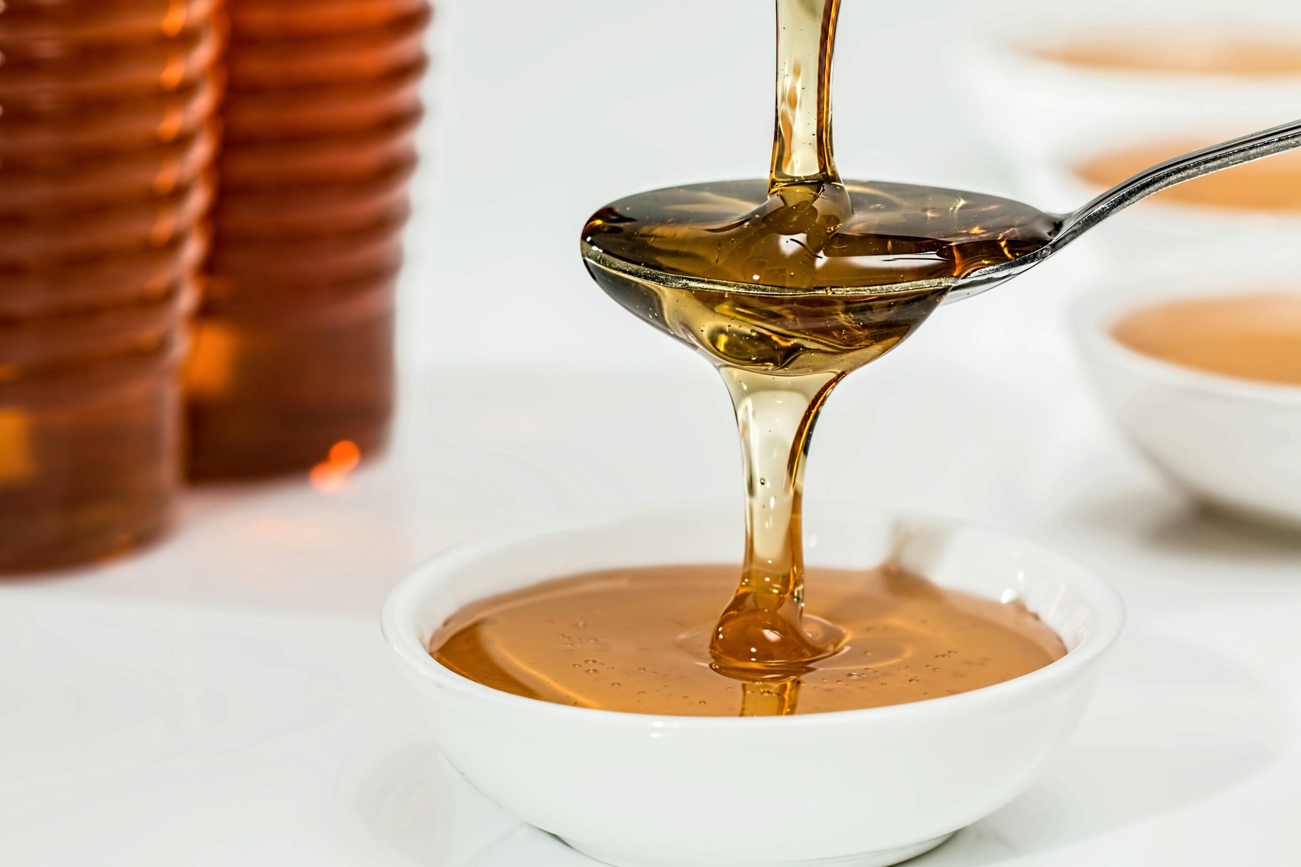 honey pouring into a bowl