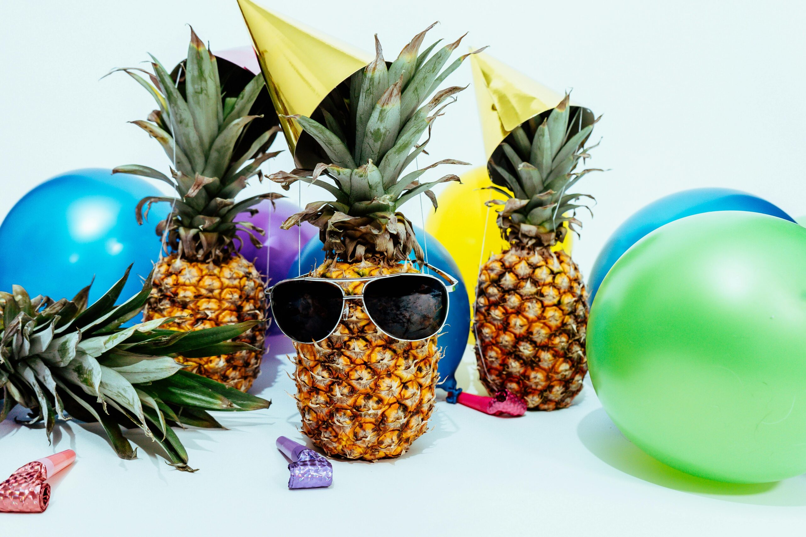 pineapples with sunglasses and balloons