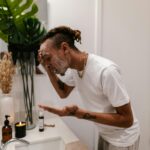 Man Washing His Face at a Sink