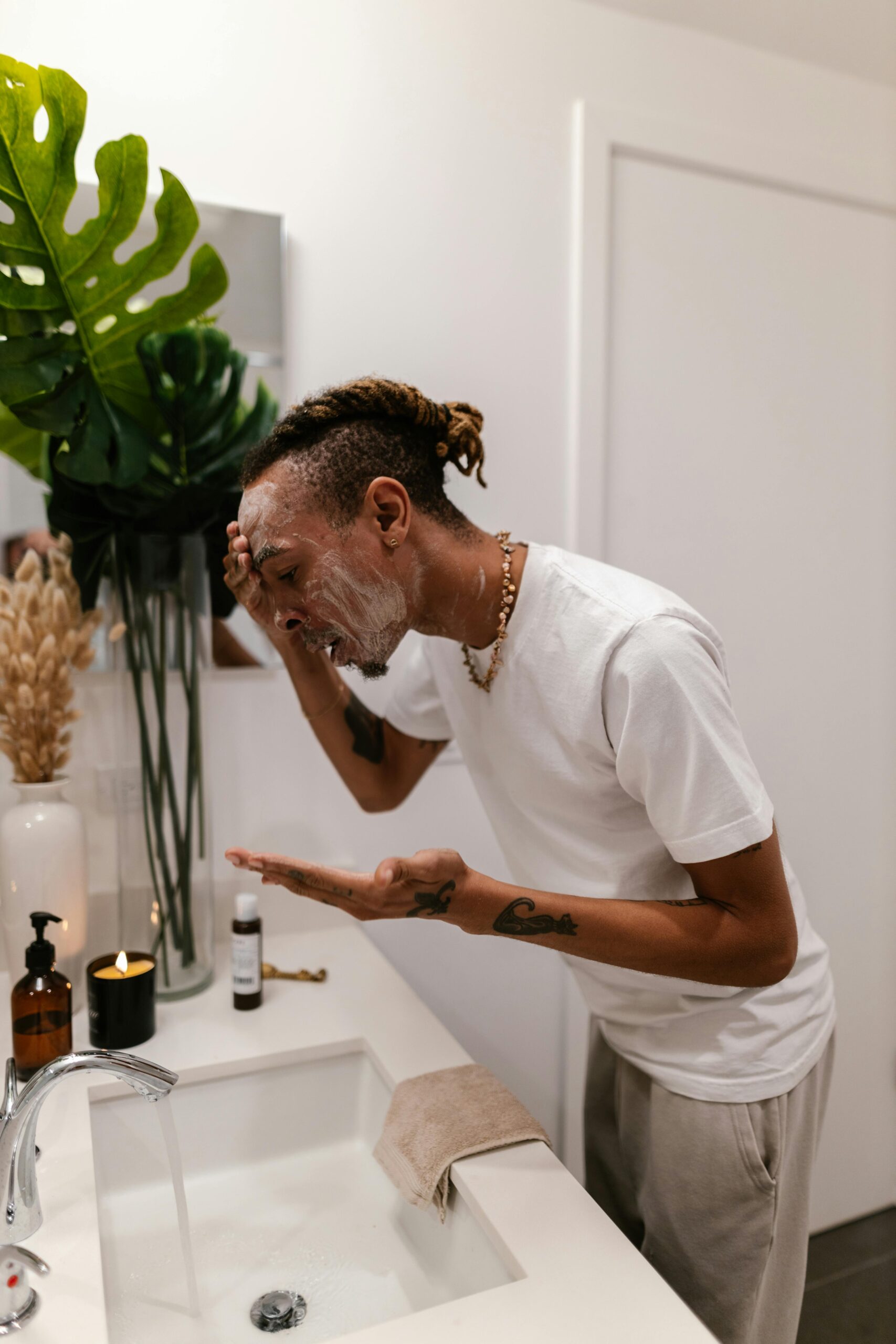 Man washing his face at a sink