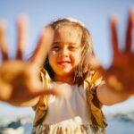 Photo of Little Girl with Her Hands out