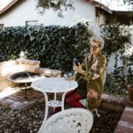 Woman Sitting at a Table in a Garden