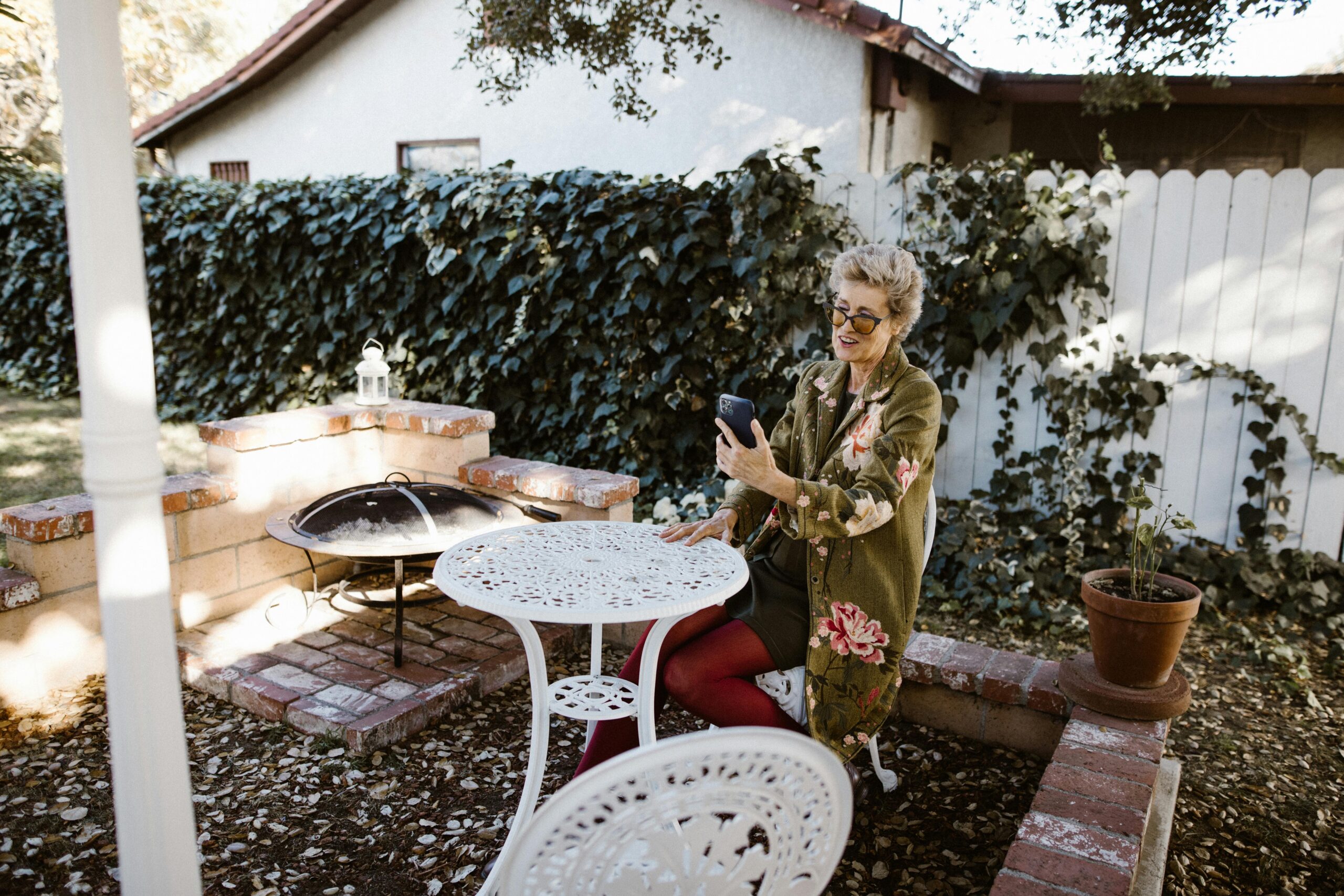 Woman sitting at a table in a garden