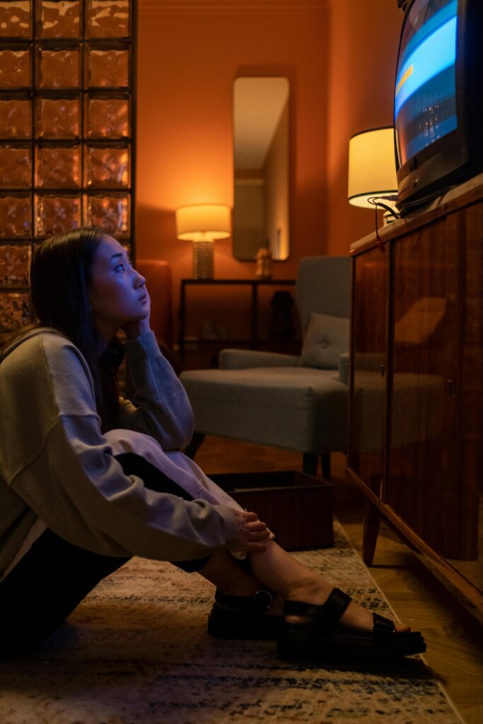 Woman Sitting on the Floor Watching Tv