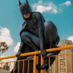 a Person Dressed As Batman on a Railing