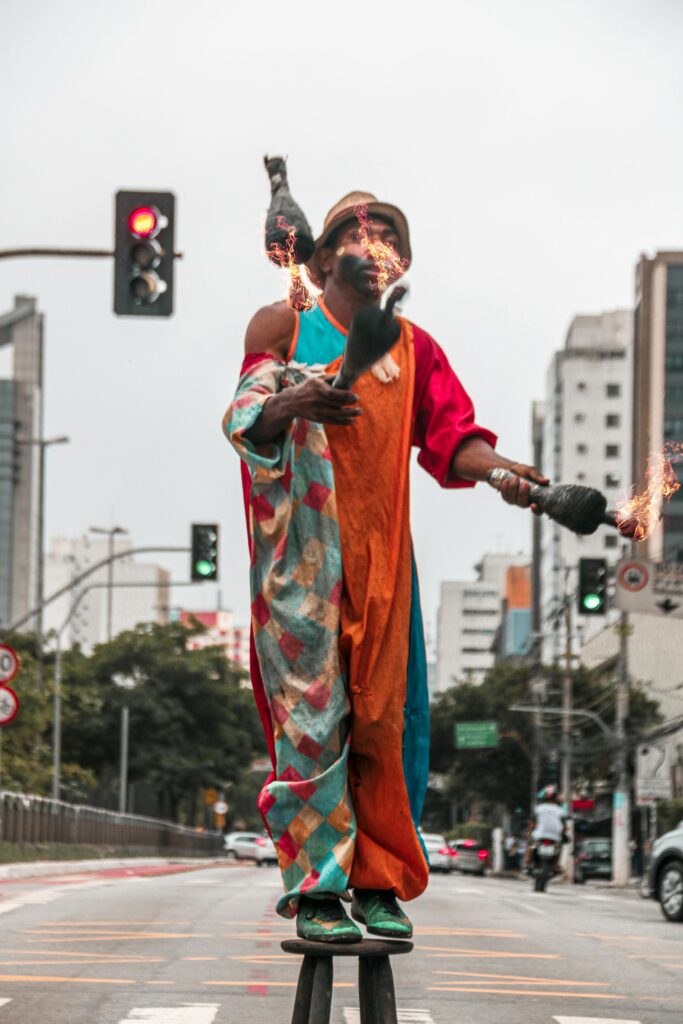 Man Standing on a Stool Juggling Fire