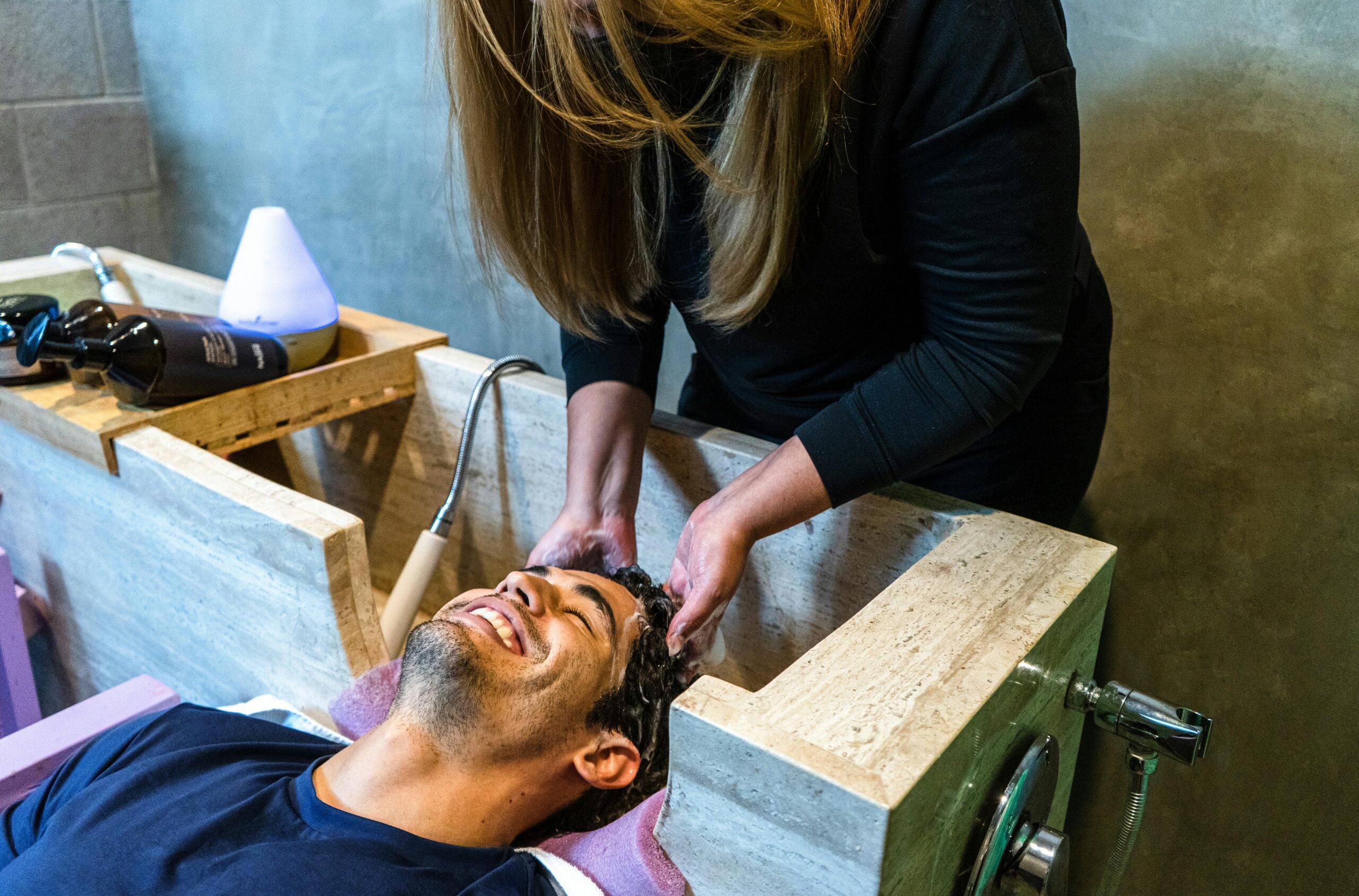 Woman washing a man's hair