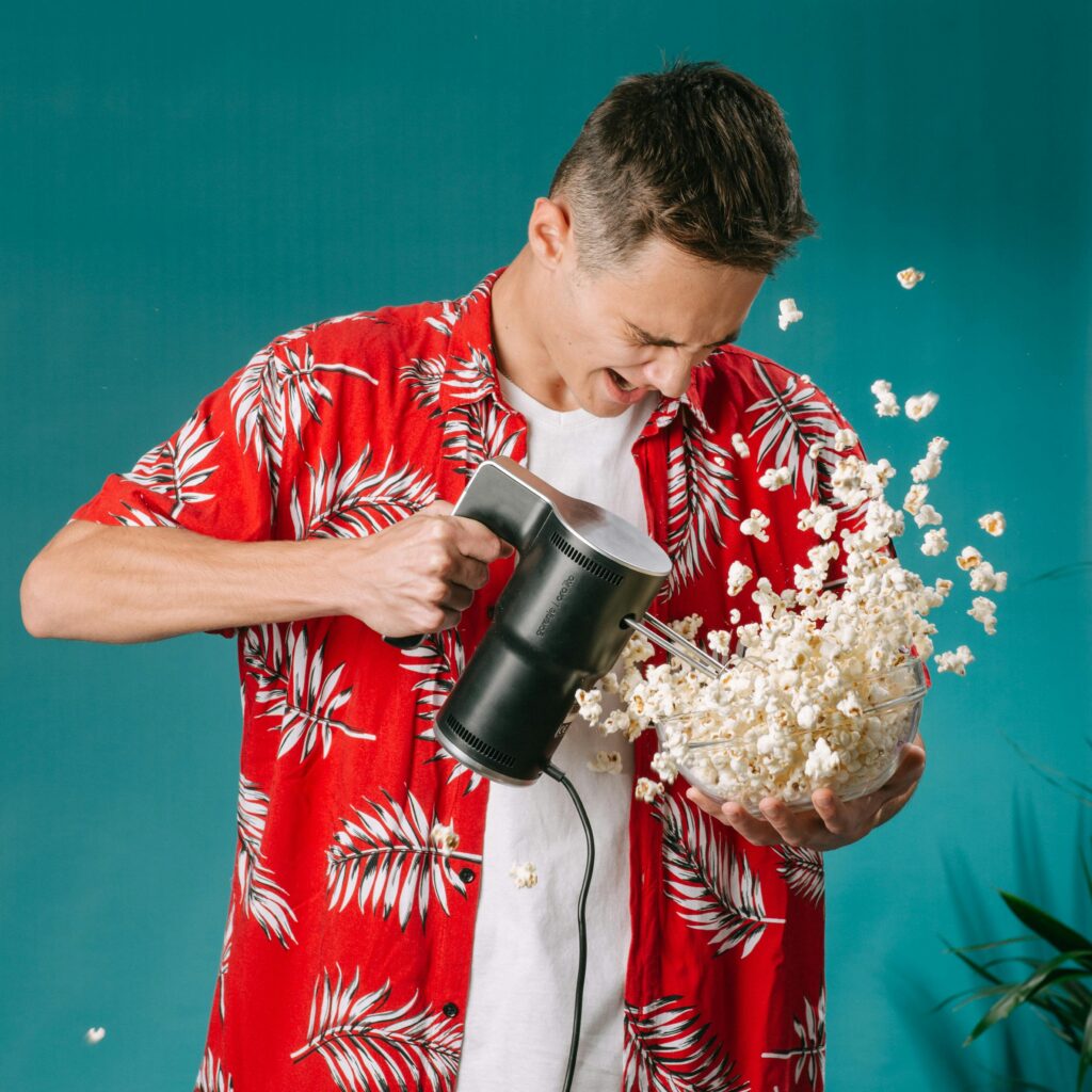 Man with Hand Mixer and Popcorn