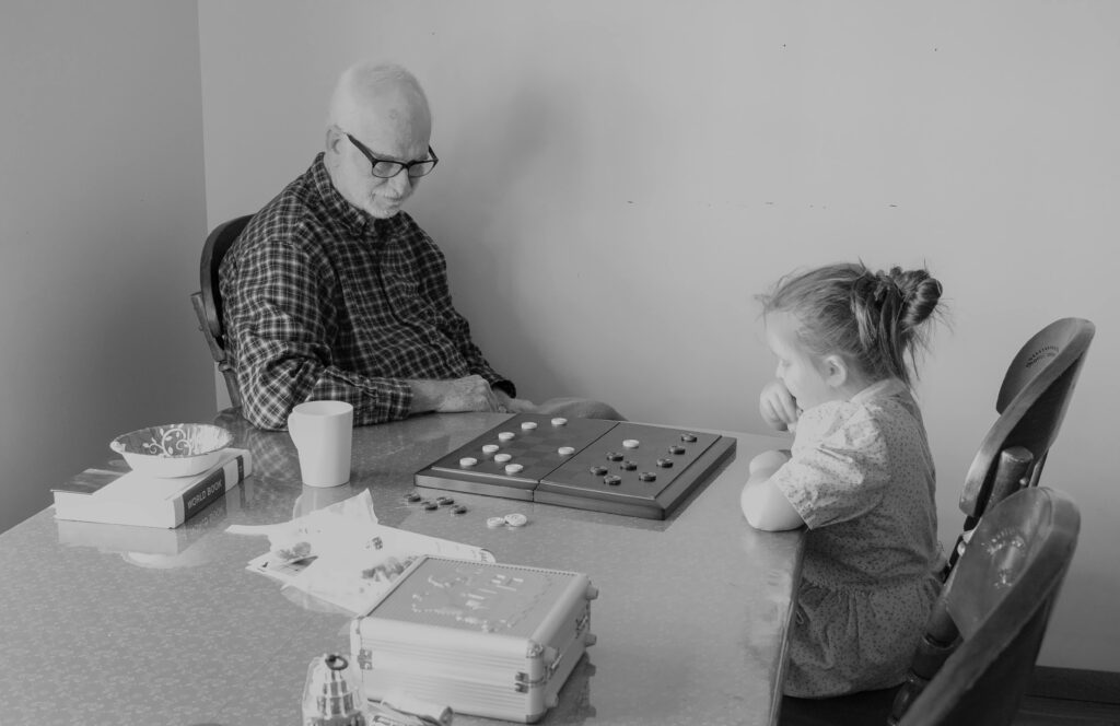 Little Girl Playing Checkers with a Man