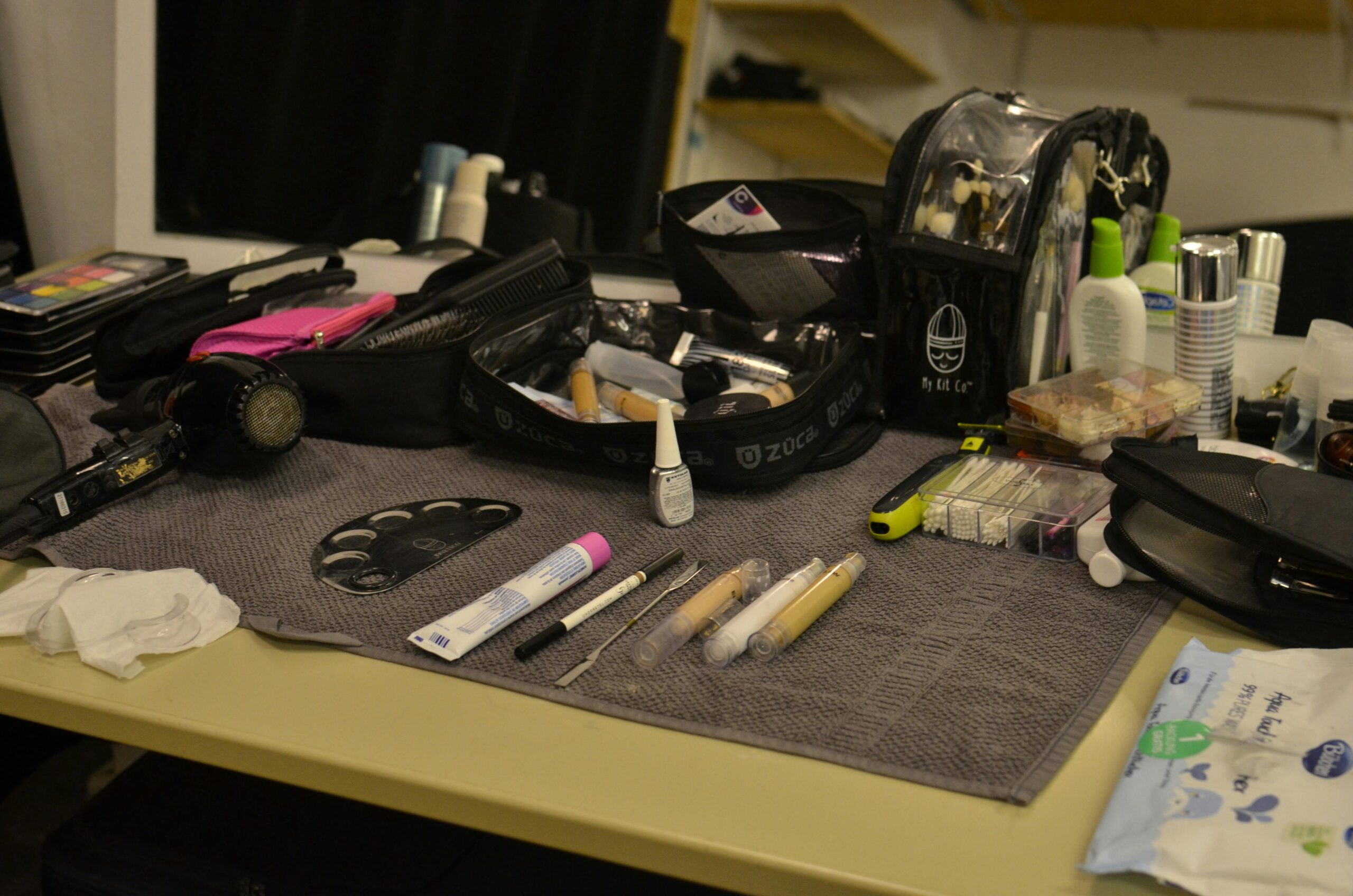 various makeup items laid out on a dresser