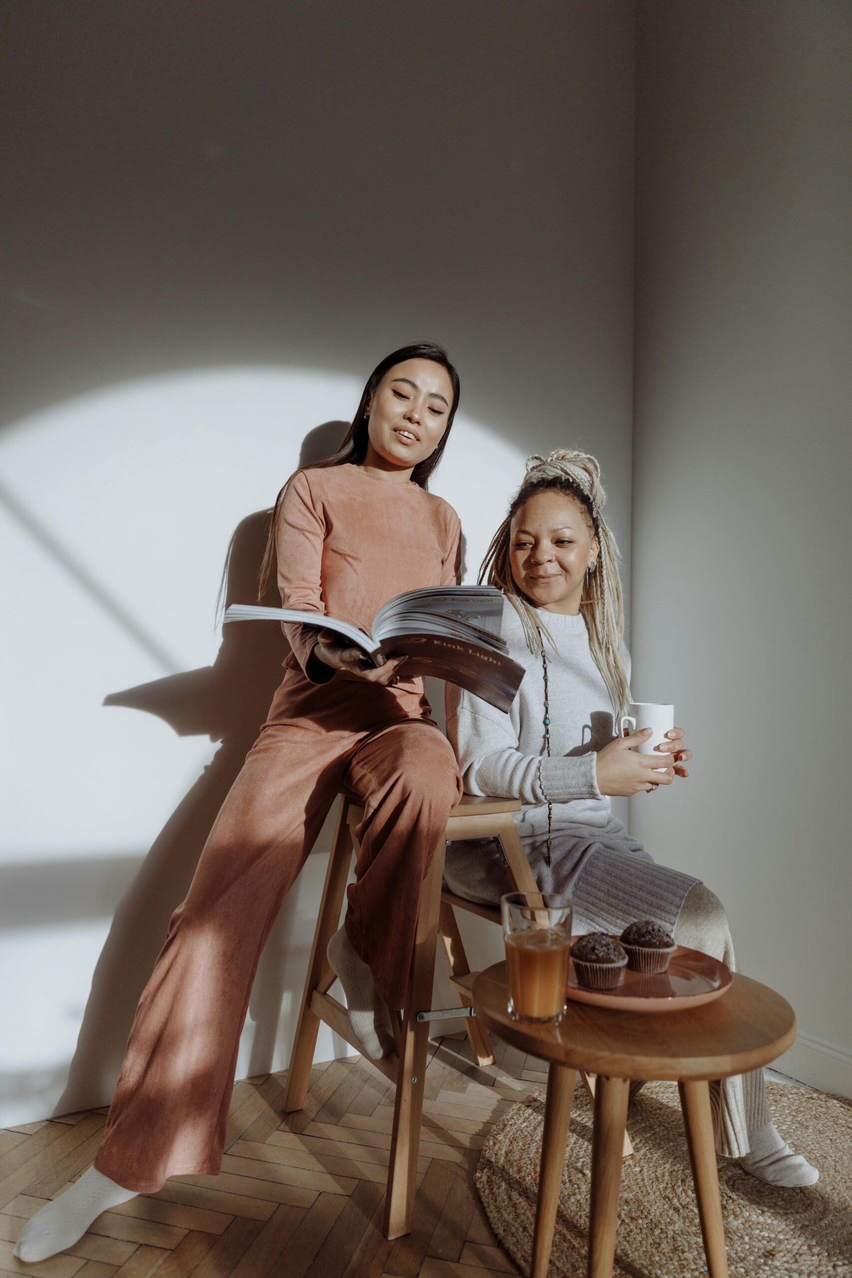 two women looking at a magazine