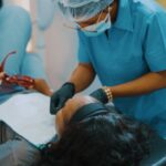 Woman Receiving Dental Treatment in a Dental Chair