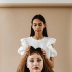 Halloween Hair Styling Woman Putting on Another Womans Wig