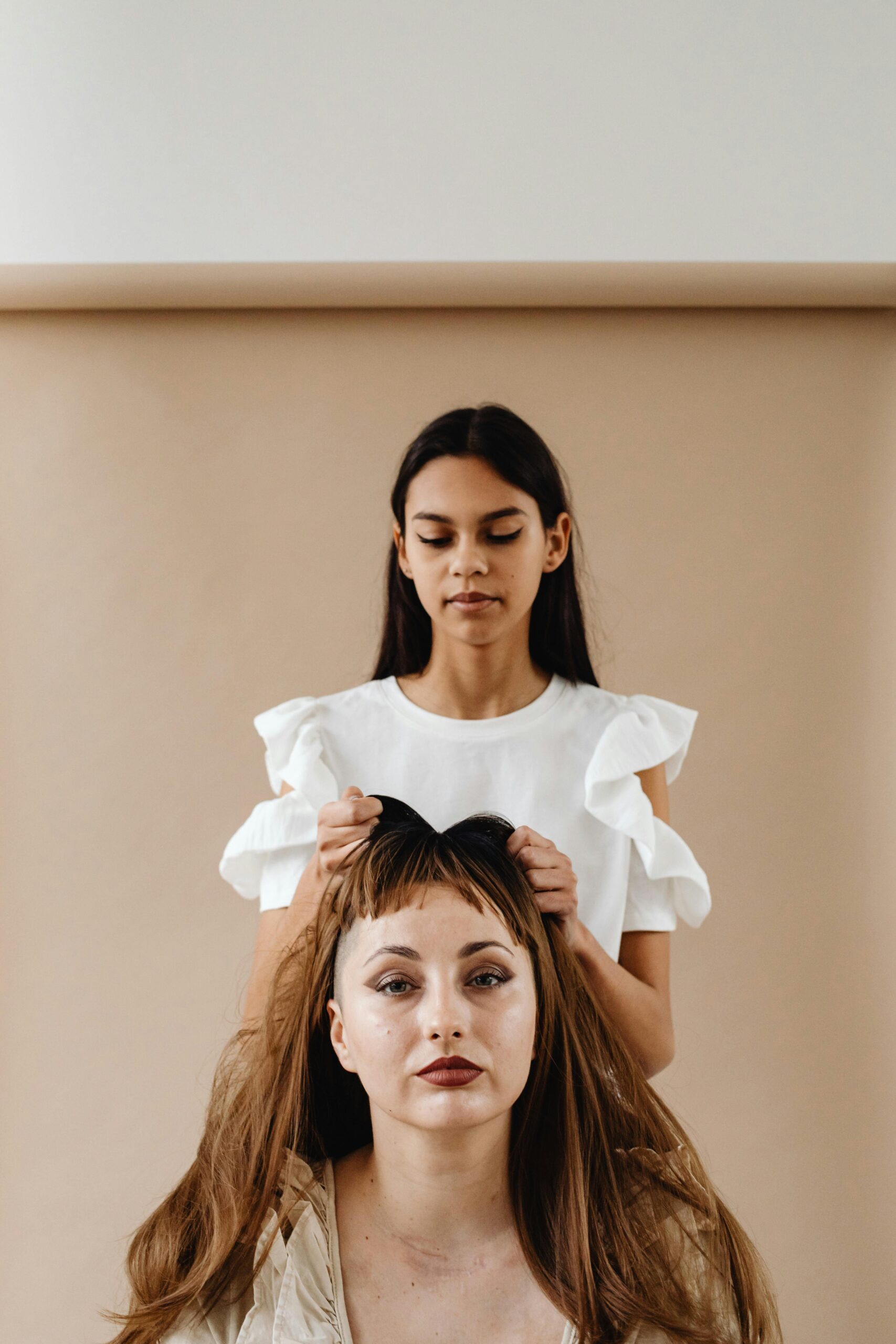 Halloween hair styling: Woman putting on another woman's wig