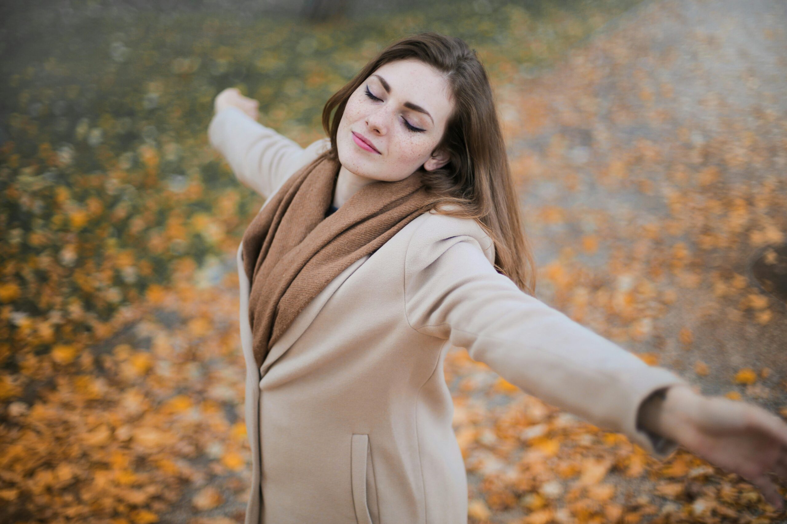 Autumn activities woman enjoying fall leaves