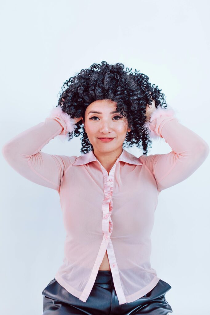 Woman Putting on a Wig