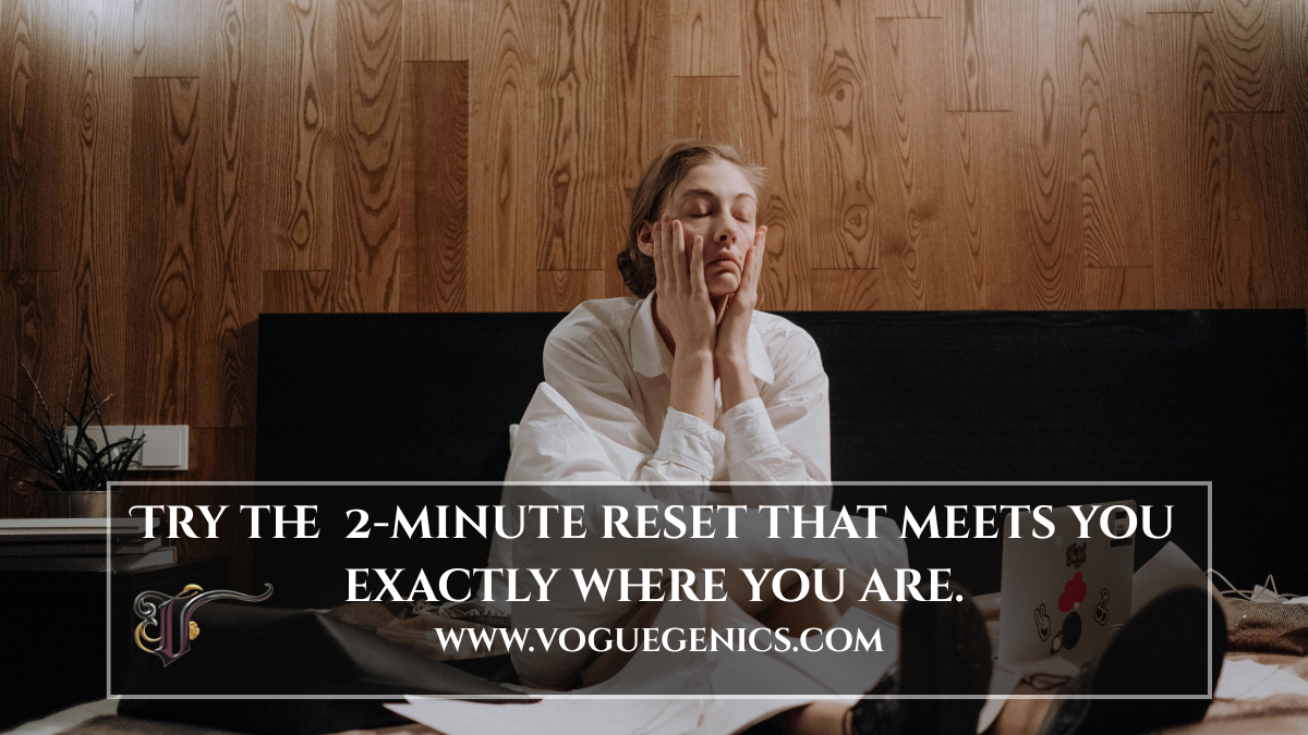 Woman sitting on a bed with her hands covering her tired face, next to a laptop, with overlaid text: “Try the 2-minute reset that meets you exactly where you are. www.Voguegenics.com”